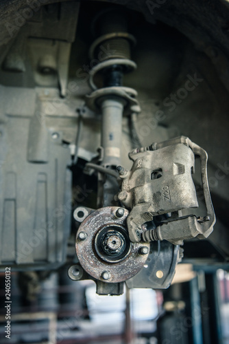 Car mechanics are replacing used brake discs.