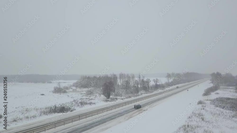 Aerial panoramic view of a winter rural landscape and traffic on the road Aerial panoramic view of a winter rural landscape and traffic on the road