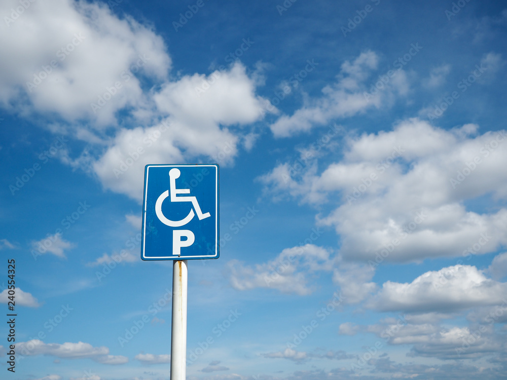 Blue handicap parking with white clouds and blue sky background Blue handicap parking with white clouds and blue sky background