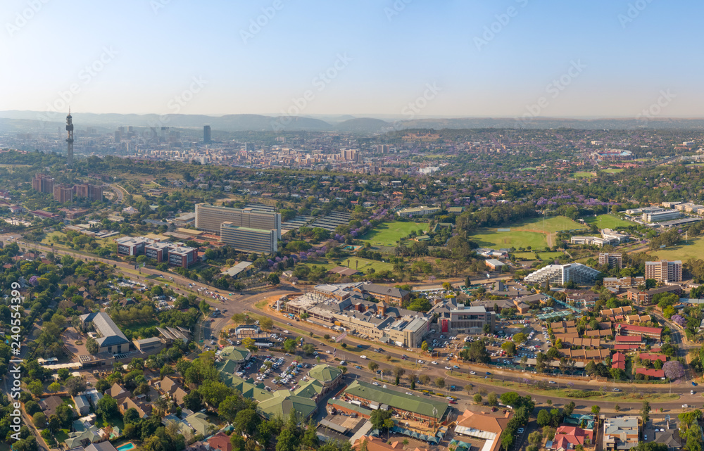 Panoramic aerial photo of Pretoria. Groenkloof Hospital, South African Bureau of Standards and University of Pretoria Groenkloof Campus close, Telkom Tower, city skyline and Magaliesberg hills further