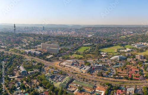 Panoramic aerial photo of Pretoria. Groenkloof Hospital, South African Bureau of Standards and University of Pretoria Groenkloof Campus close, Telkom Tower, city skyline and Magaliesberg hills further