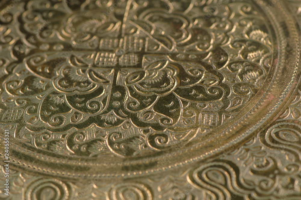 Eastern engraving on bronze, close-up Eastern engraving on bronze, close-up