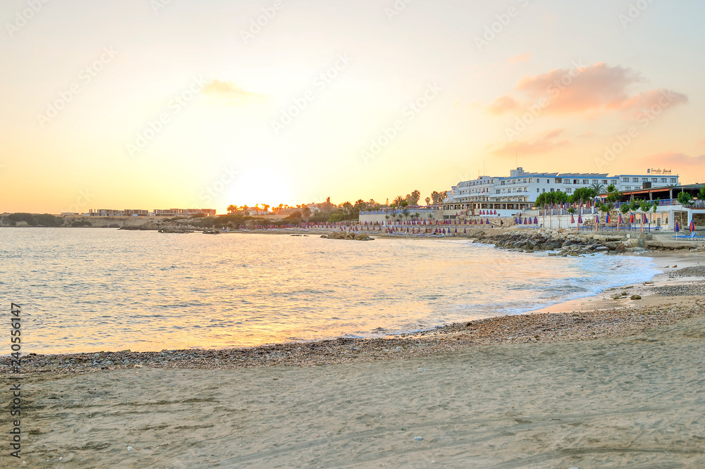 Orange sunset on the deserted beach of the Mediterranean sea
