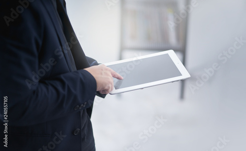 Businessman working on a digital tablet .