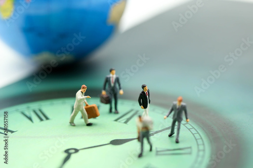 Miniature people : business man walking on the clock background, time business concept.