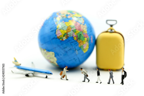 Miniature people : Businessman walking with Suitcase,mini worldmap, and airplane,travel concept.