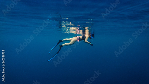 Free diver relaxing in the surface in preparation for a deep dive