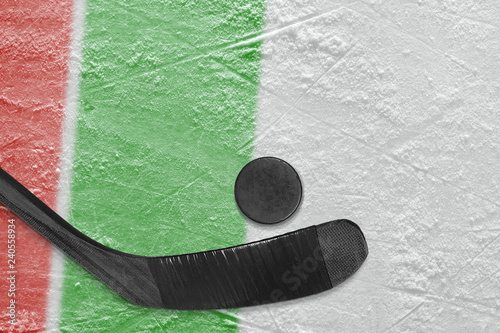 Hockey stick, puck and ice arena fragment with red and green lines