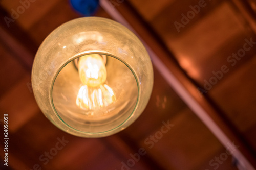 Retro lamp light decorative hanging on wooden roof © Mumemories