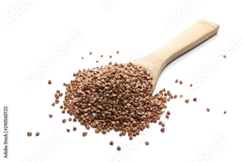 Buckwheat with wooden spoon isolated on white background
