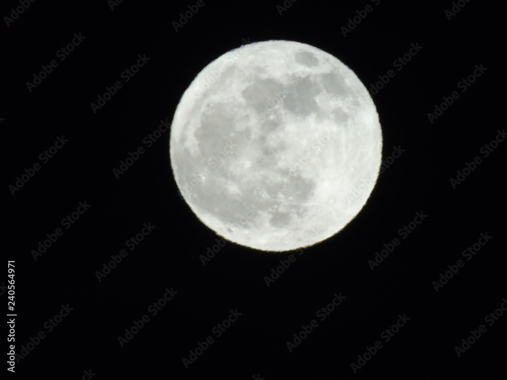 An amazing photography of the full moon over the city of Genova by night with a great clear sky in background and some stars An amazing photography of the full moon over the city of Genova by night with a great clear sky in background and some stars