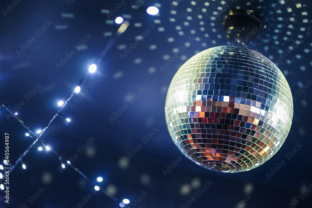 Fototapeta premium Bright mirror ball disco ball under the ceiling. 