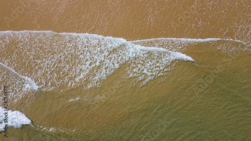 Aerial view beautiful of sea waves, sand from drone. Stock image ocean water, sea surface, sand. Top view on turquoise waves, clear water surface texture. Top view, amazing nature beach background