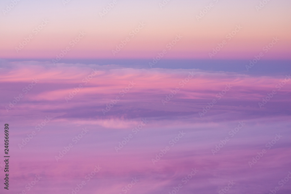 Aerial view across high level cloud as the sun sets