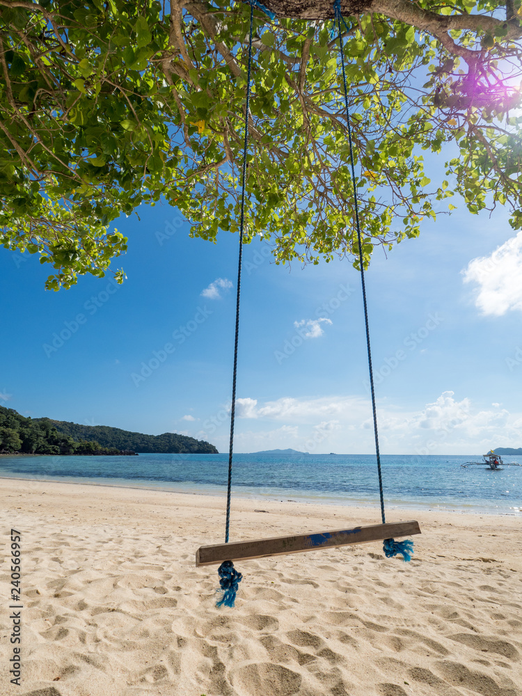 Wooden swing under tree on the beautiful beach, Scenery of beautiful  destination island, Banana island, Philippines. November, 2018 Stock Photo  | Adobe Stock