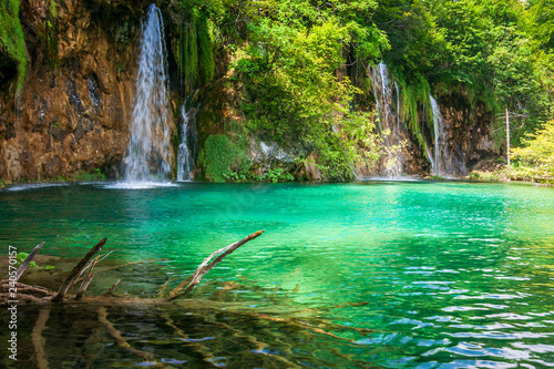 Waterfall at a turquoise lake. The Plitvice Lakes National Park, Croatia, Europe.
