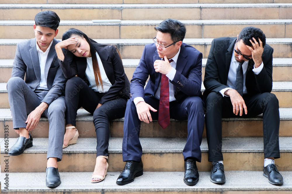 Fototapeta premium Asian businessmen sitting dismal because of unemployment.