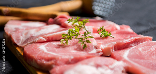 close up scene of pork steak meat with parsley. raw meat steaks