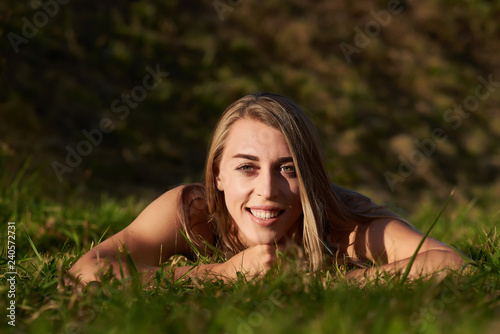 girl - blonde lying in the green grass