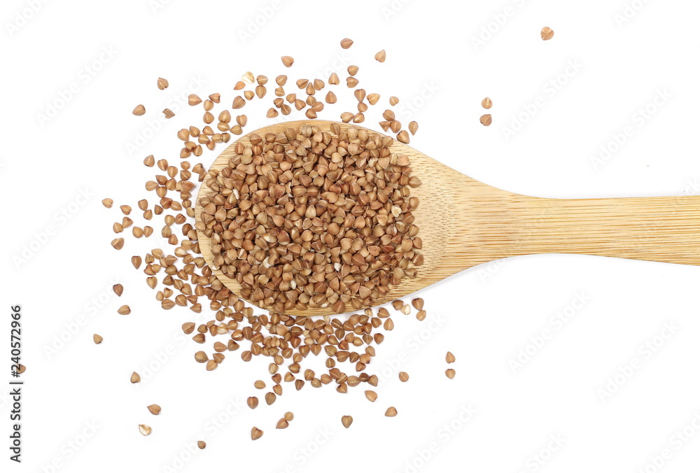 Buckwheat with wooden spoon isolated on white background, top view Buckwheat with wooden spoon isolated on white background, top view