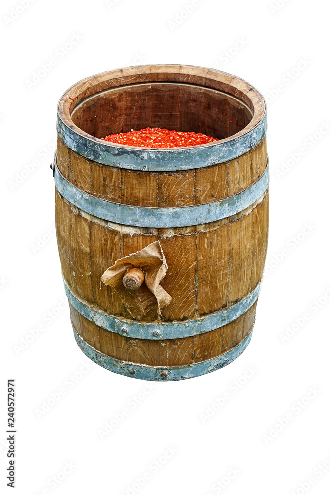 Oak Barrel. Open wooden barrel filled with milled hot pepper. Isolated on white background