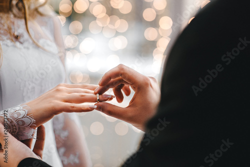 Wedding rings put on a finger