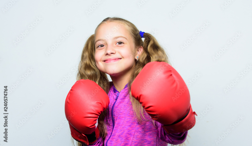 Boxing sport for female. Sport upbringing. Skill of successful leader. Sport upbringing for leader. Girl cute child with red gloves posing on white background. Cute kid with sport boxing gloves Boxing sport for female. Sport upbringing. Skill of successful leader. Sport upbringing for leader. Girl cute child with red gloves posing on white background. Cute kid with sport boxing gloves