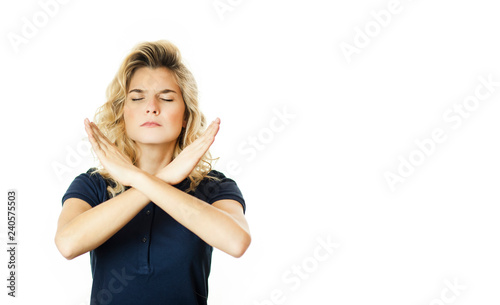 Portrait of a serious woman holding a pair of crossed hands, showing no sign, isolated on a white background.