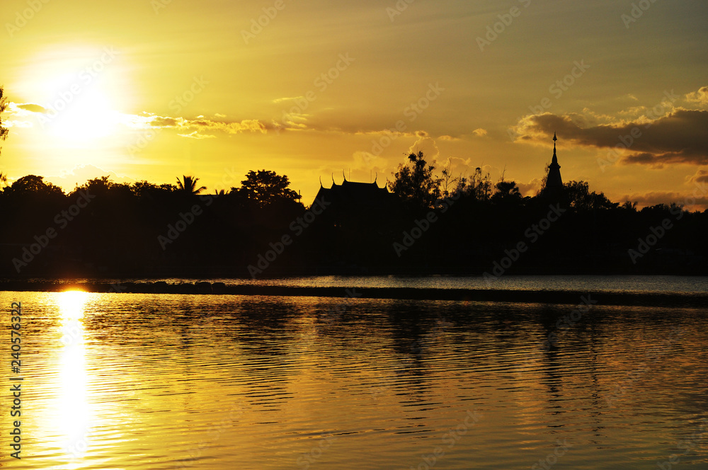 Beautiful sunset over the lake in Thailand in orange color background