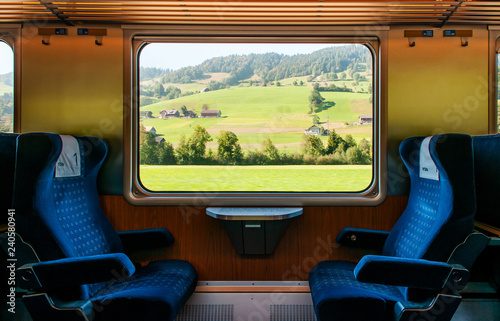 Swiss rural farmland through train window, Train travel concept. photo