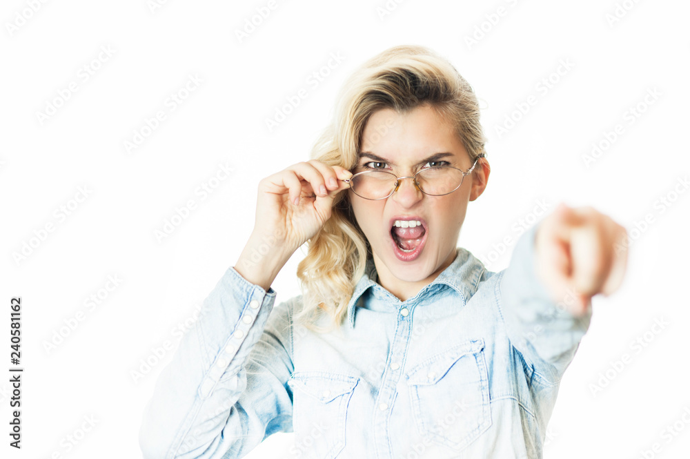 Young beautiful girl teacher in glasses emotionally reeks and shouts with a finger. Concept is evil doctor Young beautiful girl teacher in glasses emotionally reeks and shouts with a finger. Concept is evil doctor