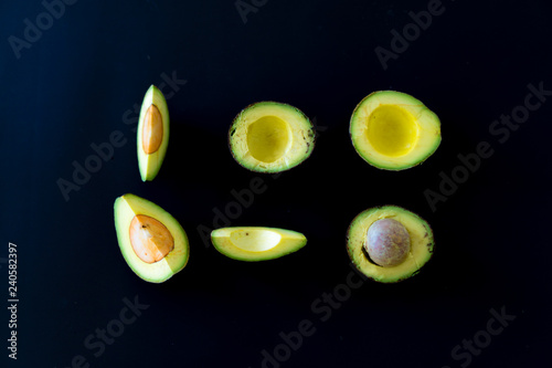 sliced avocado on black background