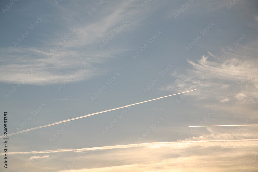 Sky background beautiful image. Abstract background is decorated with different types of clouds. Sunset in the evening sky. The sun's rays illuminate the clouds.