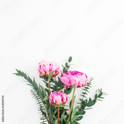 Fototapeta Naklejka Na Ścianę i Meble -  Bouquet of pink peonies, hypericum and eucalyptus on white background. Flat lay, top view