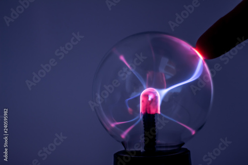 A plasma lamp with pink electricity rays. photo