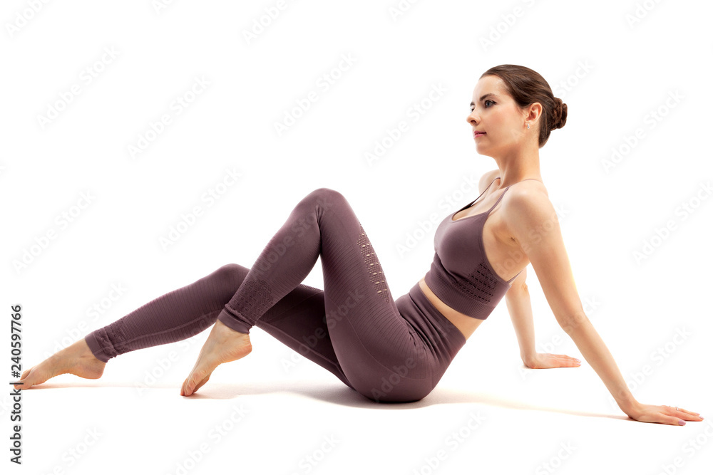 Young beautiful yoga sports woman is posing in studio on white background Young beautiful yoga sports woman is posing in studio on white background