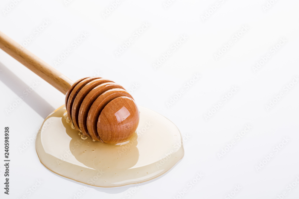 Honey and honey dipper on white background Honey and honey dipper on white background