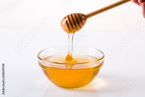 Honey with dipper and flowing honey