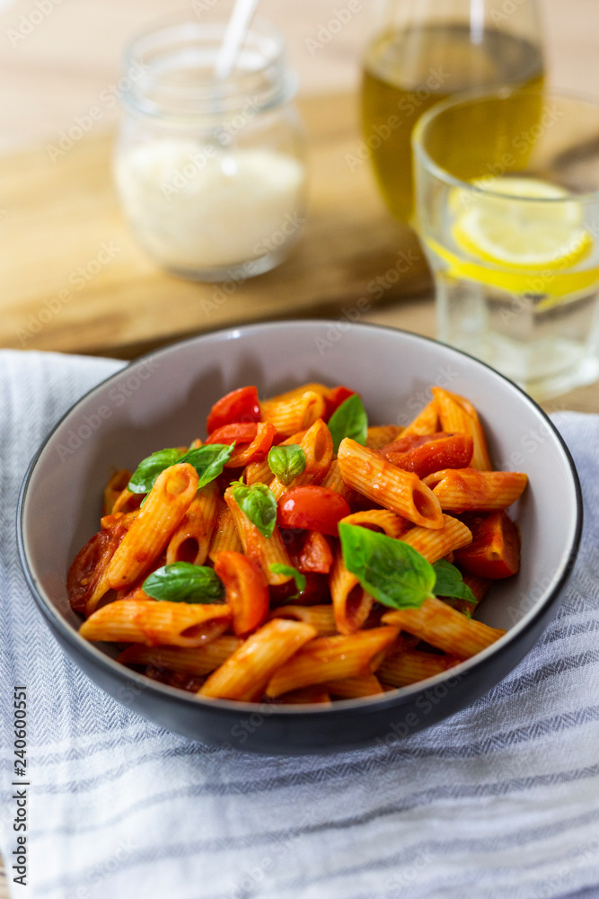 Penne with tomato and basil in bowl Penne with tomato and basil in bowl