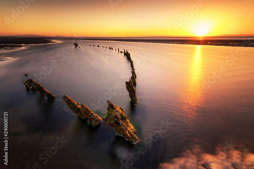 Great Britain, Scotland, East Lothian, Aberlady Nature Reserve, Shipwreck at sunset photo