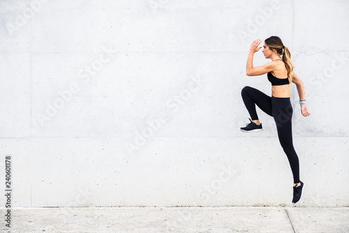 Athlete jumping in front of white wall