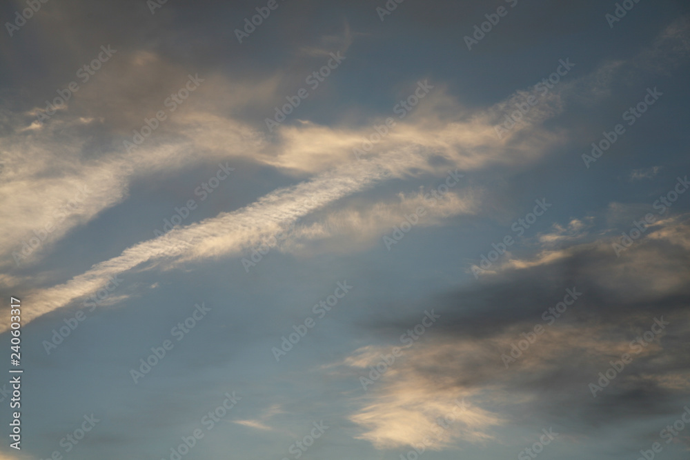 The sky background as the image. Abstract clouds and sky. The best images of heaven with clouds. Evening sunset. The sun's rays illuminate the clouds. The sky background as the image. Abstract clouds and sky. The best images of heaven with clouds. Evening sunset. The sun's rays illuminate the clouds.