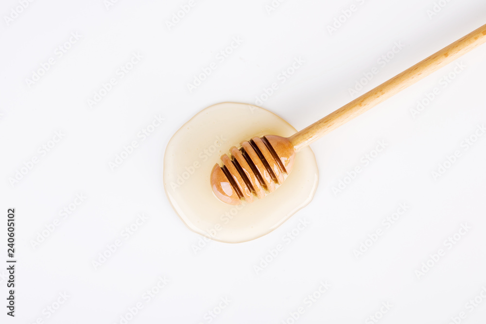 Top view of honey and honey dipper on white background Top view of honey and honey dipper on white background