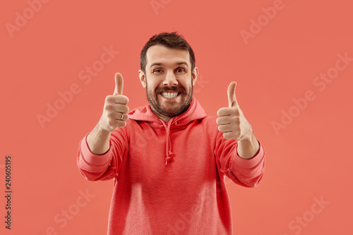 I am ok. Happy businessman, sign ok, smiling, isolated on trendy coral studio background. Beautiful male half-length portrait. Emotional man. Human emotions, facial expression concept