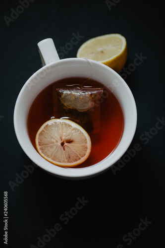 Close up of a tea cup with lemons