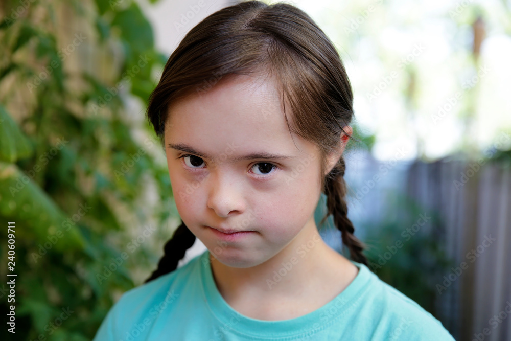 Portrait of down syndrome girl in the garden Portrait of down syndrome girl in the garden