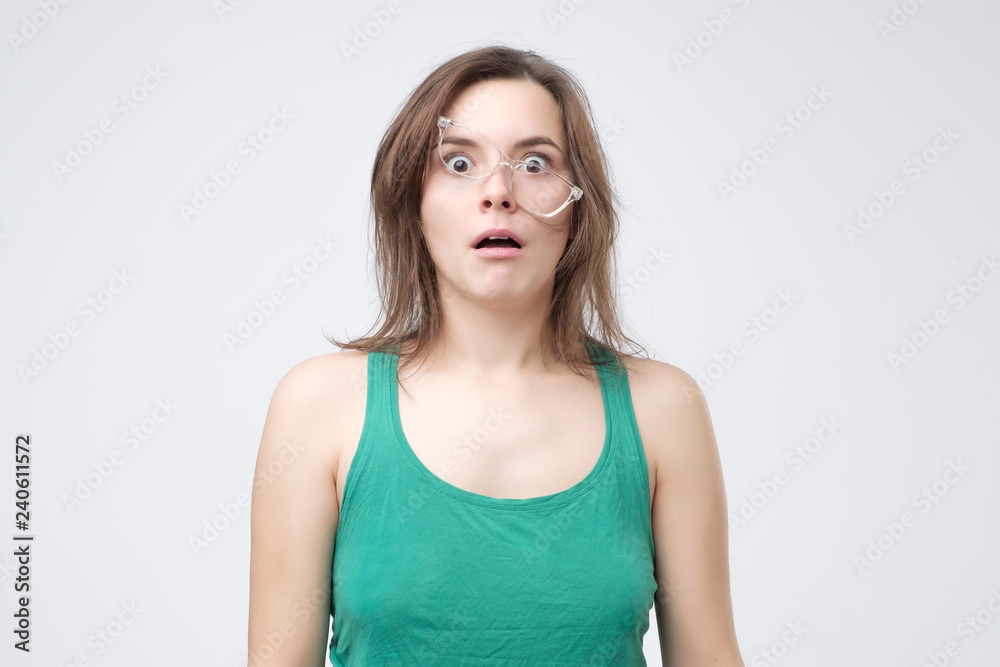 Upset handsome woman tired of wearing glasses. Sad young femalr failing in putting on eyeglasses. Tired student after night of preparation for exam. Upset handsome woman tired of wearing glasses. Sad young femalr failing in putting on eyeglasses. Tired student after night of preparation for exam.