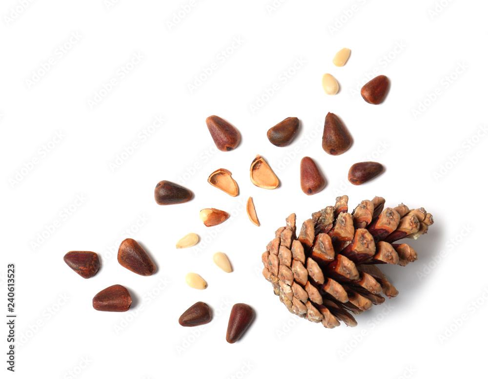 Obraz premium Composition with pine nuts and cone on white background, top view