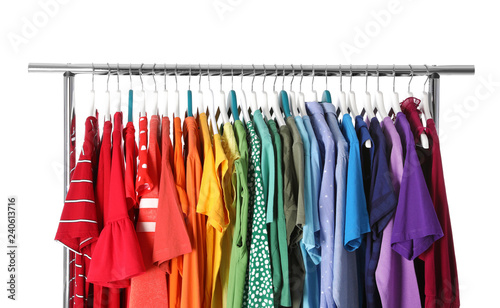 Wardrobe rack with different colorful clothes on white background