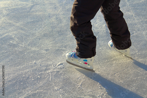 Girl skates on the ice rink. Background. Texture.